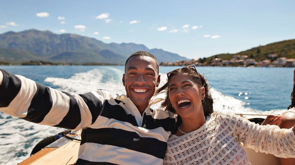 Couple smiling on a speedboat